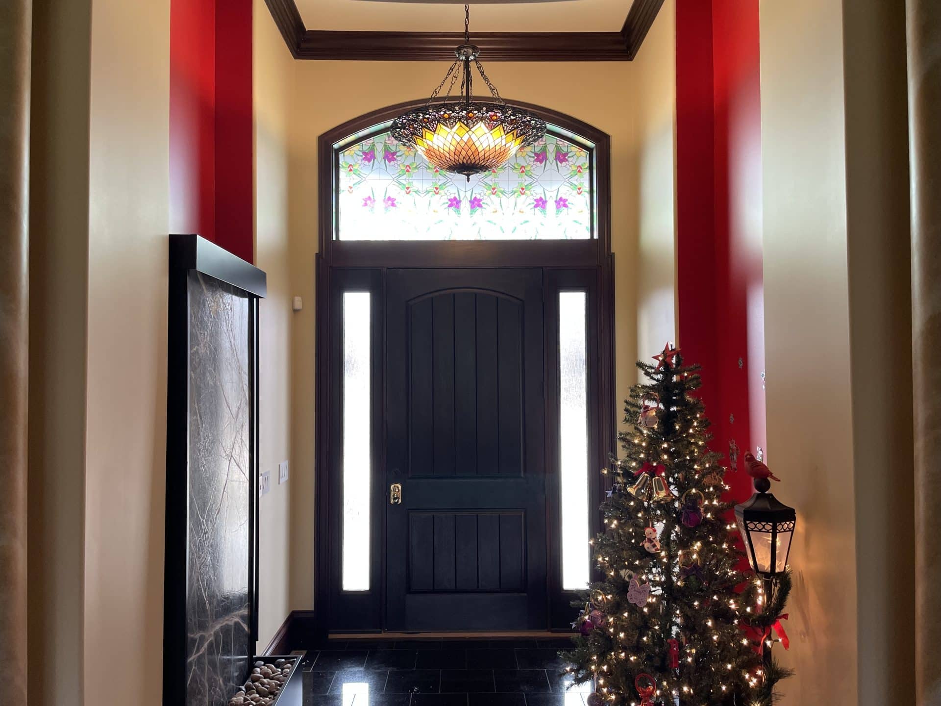Entry door with decorative window film above and on the sides.