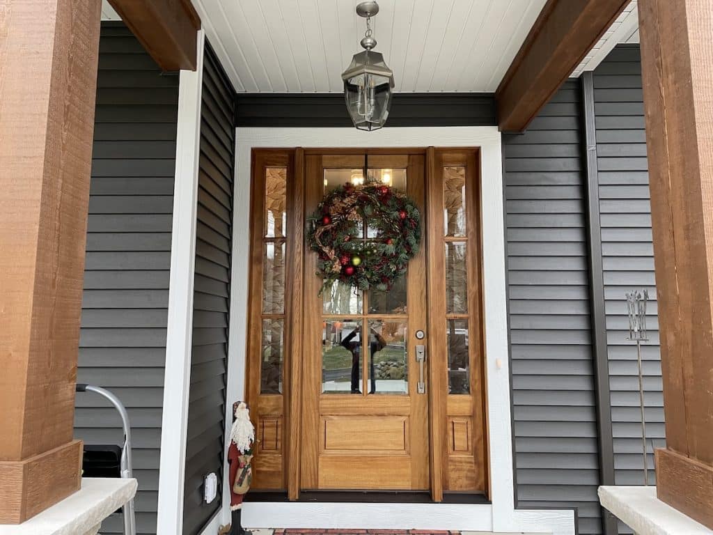 Entry door with decorative window film on the glass.