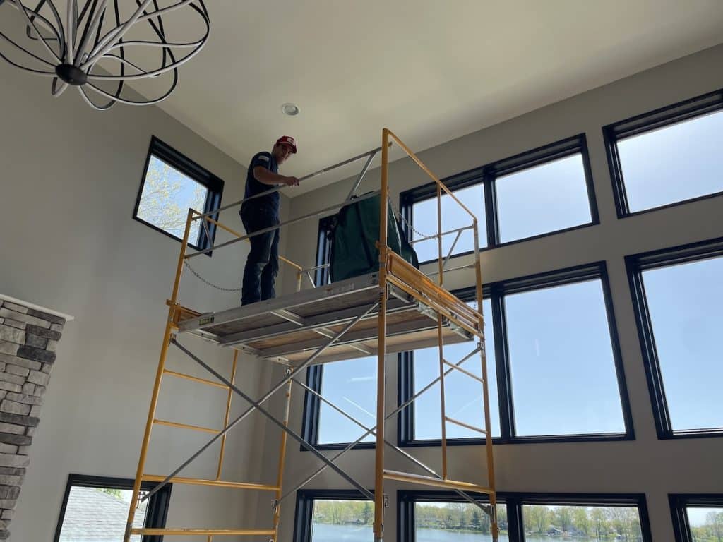 standing on scaffolding applying window film