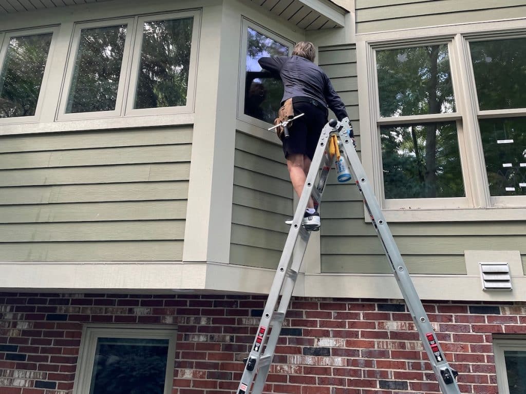 applying bird safety window film to a home