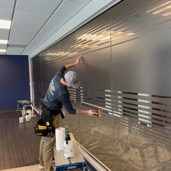a man working on a window installation in an office